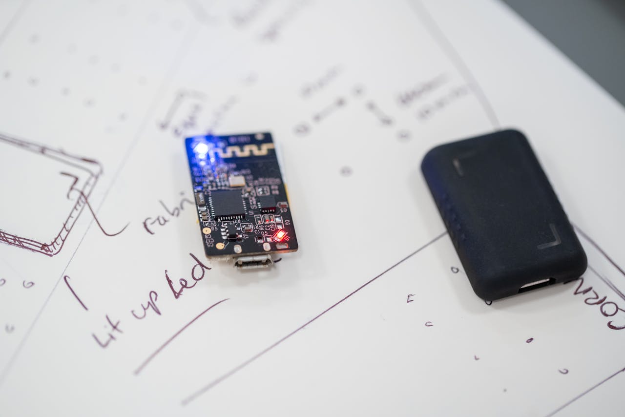 Close-up of a microprocessor and circuit board placed on technical design sketches.